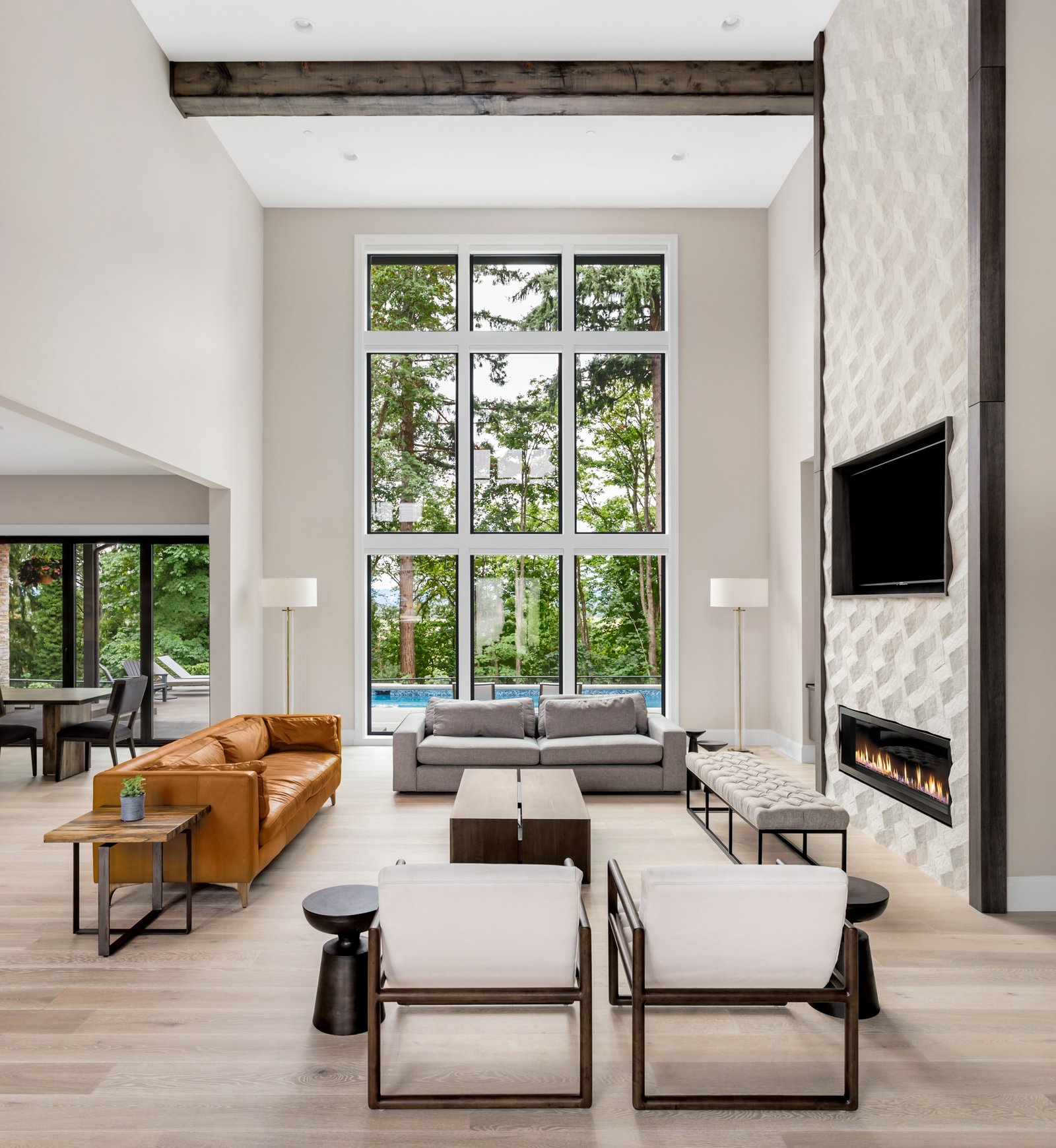 Two-story living room with fireplace by Reschka Design Build