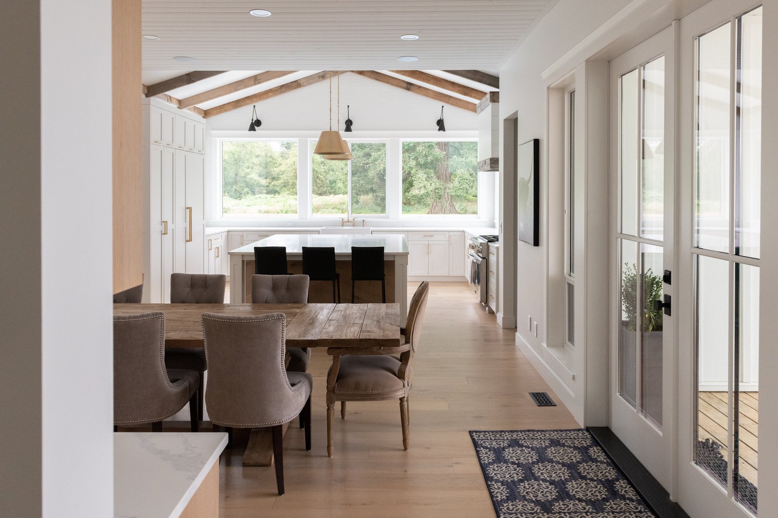 Vaulted kitchen and dining area with exposed beams in a Willow Ridge Estate custom home by Reschka Design Build